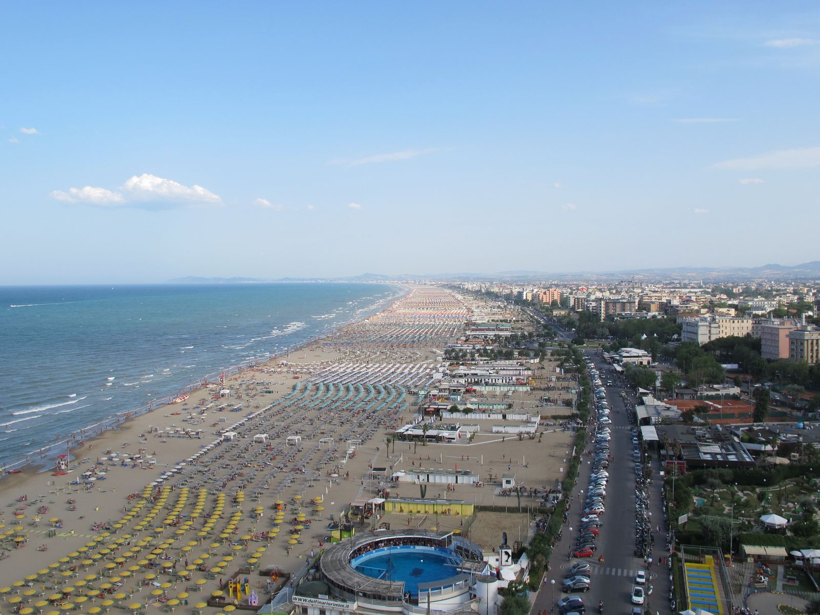 Rows of beach umbrellas along the shore at Rimini, seen from above